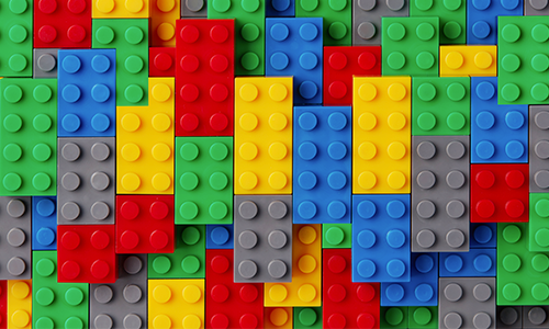 Red, green, yellow, blue and grey legos organized next to each other